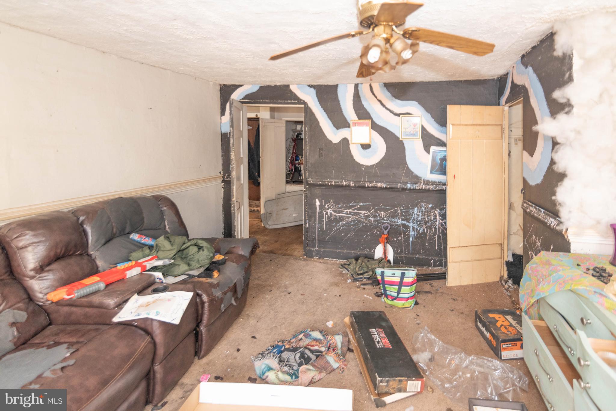 2100 Singerly Road Elkton, MD 21921 - Photo 32 of 67 a living room with furniture and a chandelier