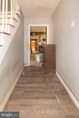 a view of a hallway view with wooden floor and staircase