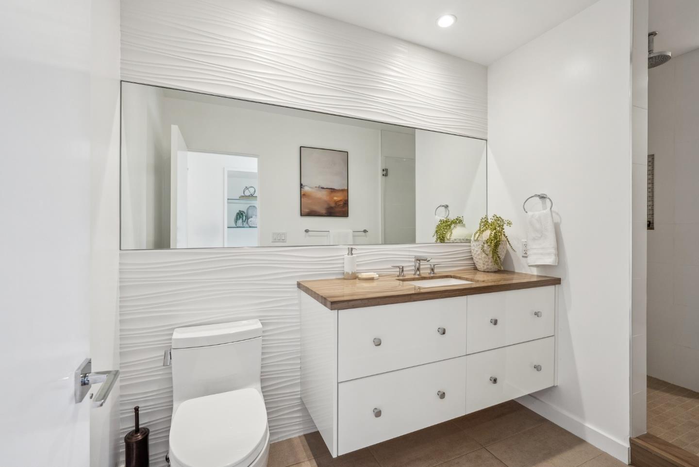 1 Millbrae Circle Millbrae, CA 94030 - Photo 42 of 110 a bathroom with a toilet a sink a mirror and vanity