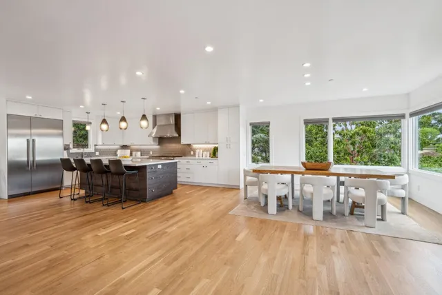 a living room with fireplace furniture and a large window