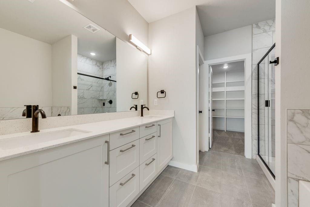 4254 Clovis Street Midlothian, TX 76065 - Photo 6 of 16 a bathroom with a double vanity sink and mirror