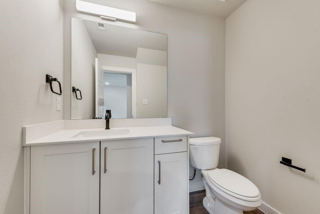 4254 Clovis Street Midlothian, TX 76065 - Photo 9 of 16 a bathroom with a sink a toilet a mirror and vanity