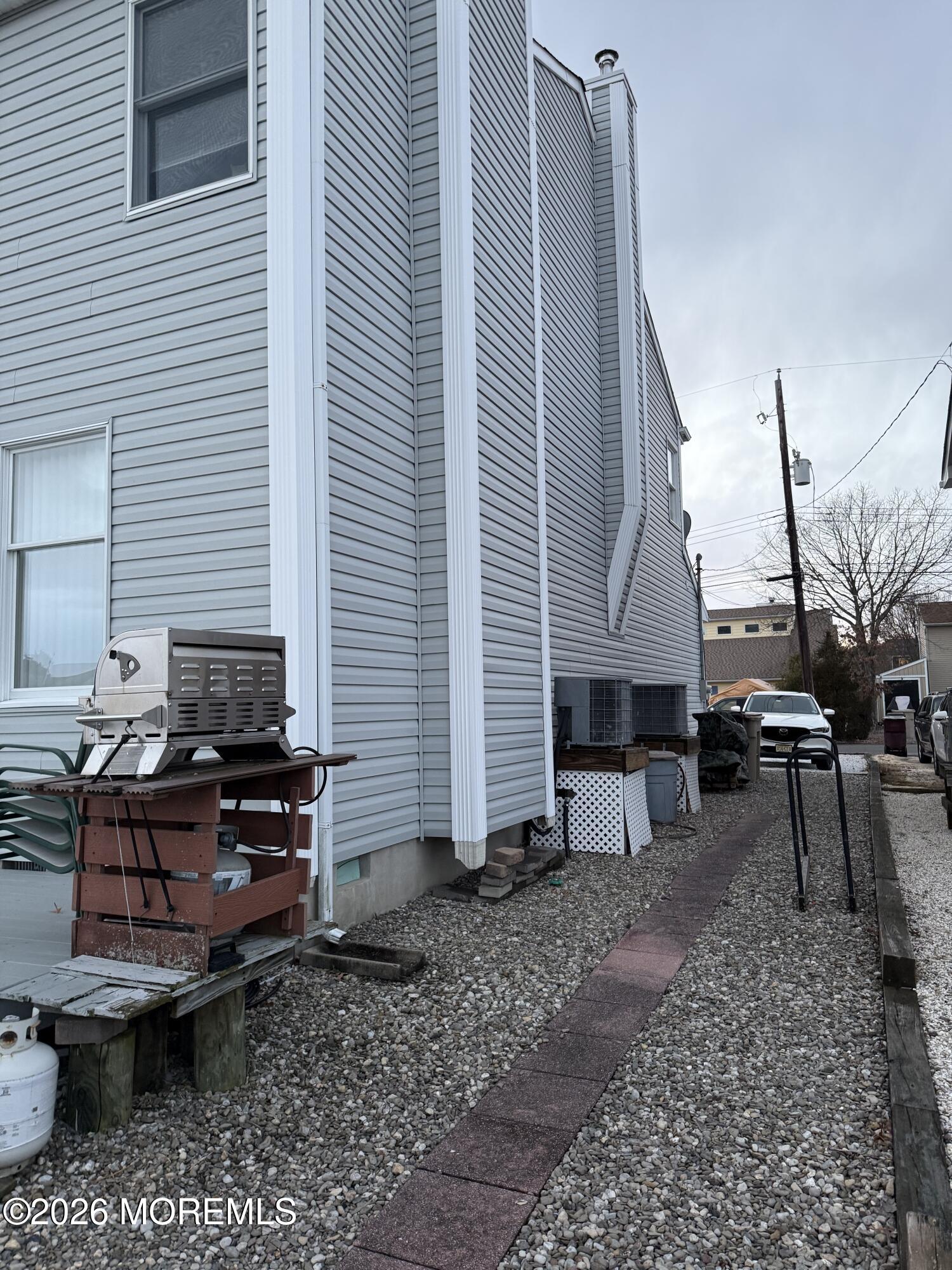 7 Albatross Point Bayville, NJ 08721 - Photo 11 of 56 a backyard of a house with barbeque oven table and chairs