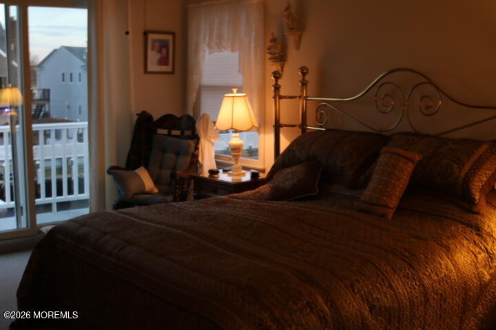 7 Albatross Point Bayville, NJ 08721 - Photo 46 of 56 a bed sitting in a bedroom next to a lamp