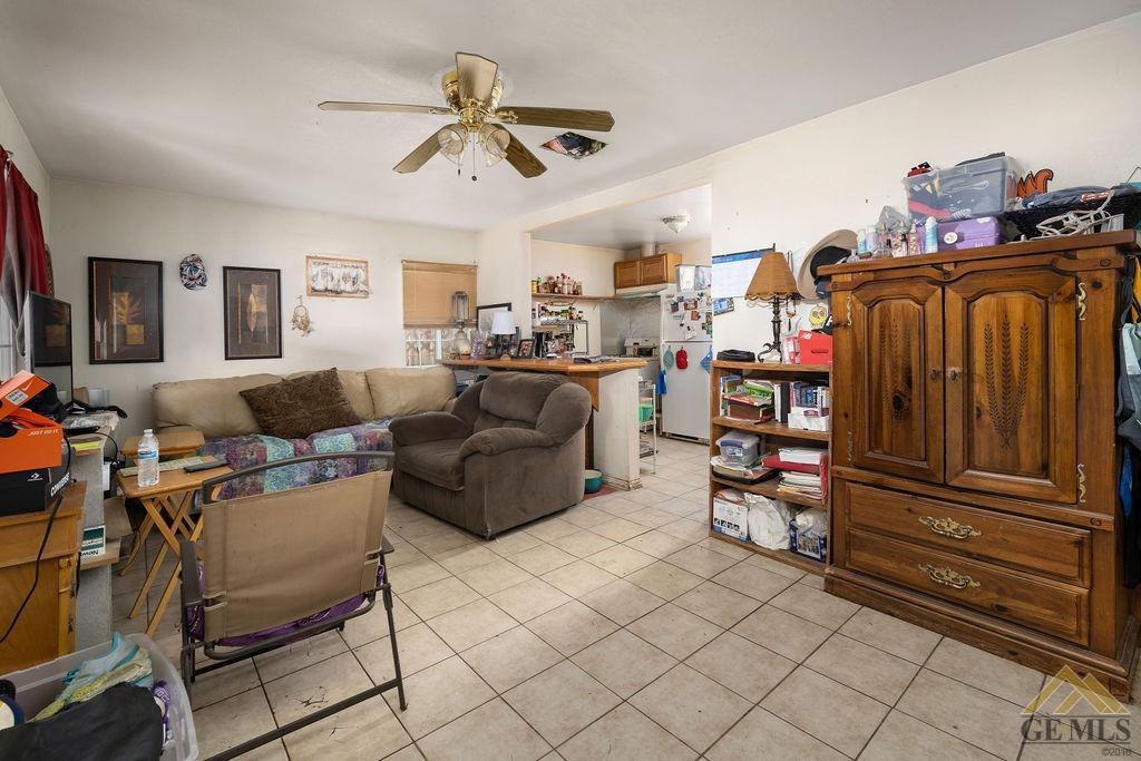Undisclosed Address Wasco, CA 93280 - Photo 19 of 29 a living room with furniture a ceiling fan and a window