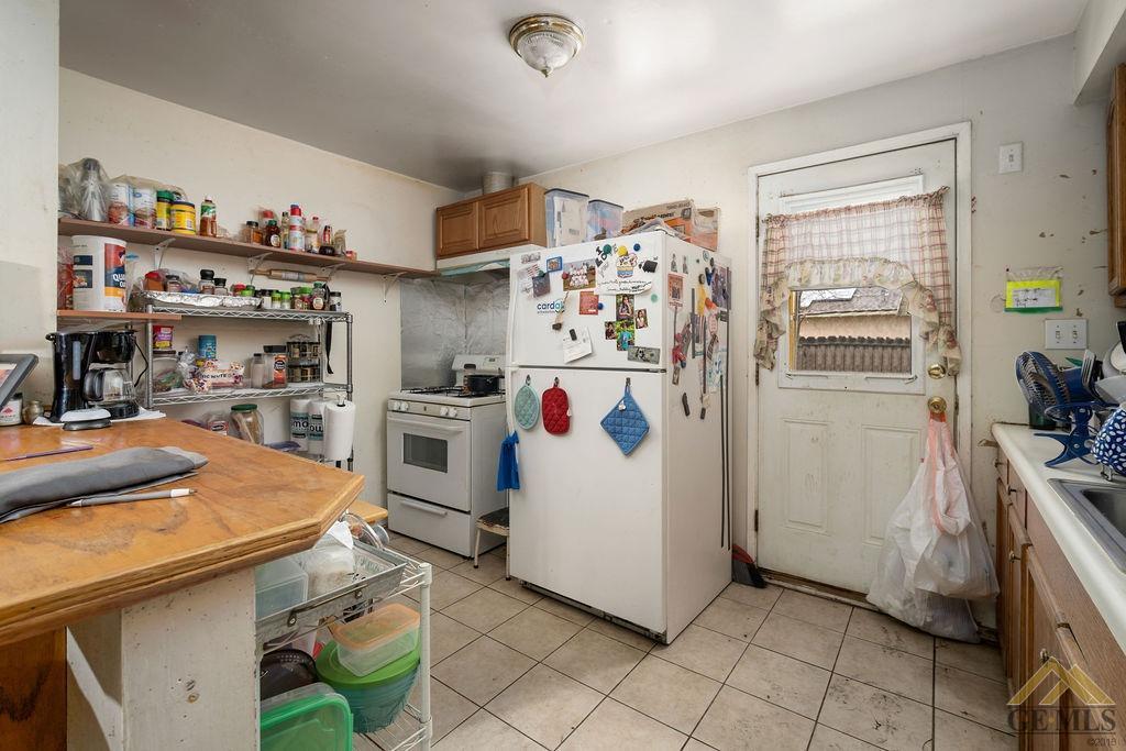 Undisclosed Address Wasco, CA 93280 - Photo 20 of 29 a kitchen with a refrigerator and a sink