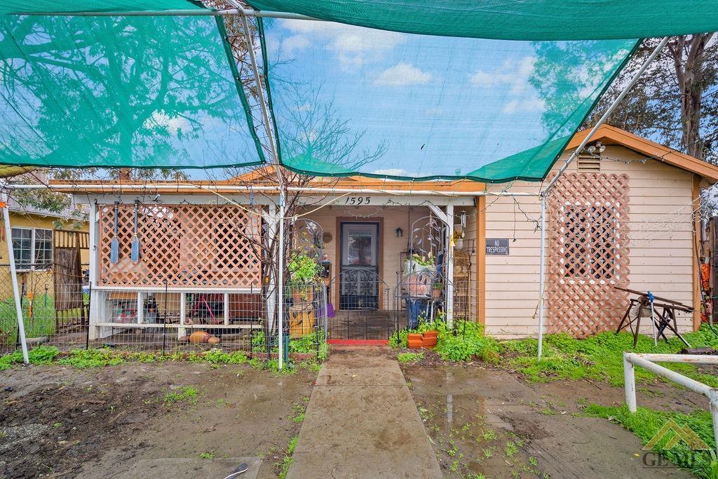 Undisclosed Address Wasco, CA 93280 - Photo 2 of 29 a front view of a house with a garden