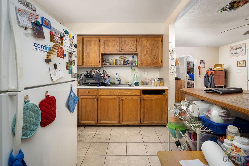 Undisclosed Address Wasco, CA 93280 - Photo 21 of 29 a kitchen with stainless steel appliances granite countertop a sink and a refrigerator