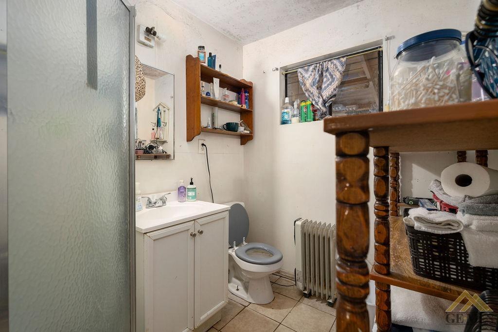 Undisclosed Address Wasco, CA 93280 - Photo 24 of 29 a bathroom with a toilet sink and mirror