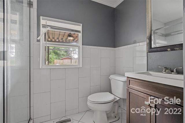 655 East Ridge Road Salisbury, NC 28144 - Photo 8 of 14 a bathroom with a toilet a sink and a window