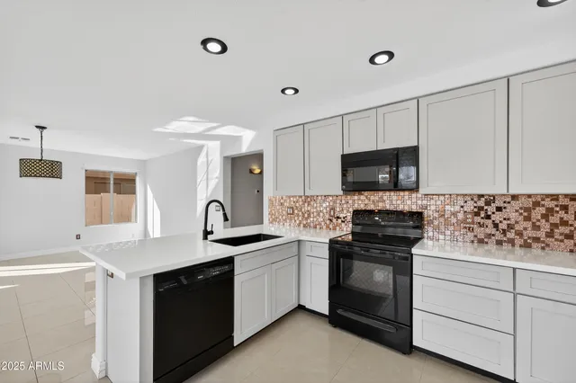 a view of a kitchen with a sink and a refrigerator
