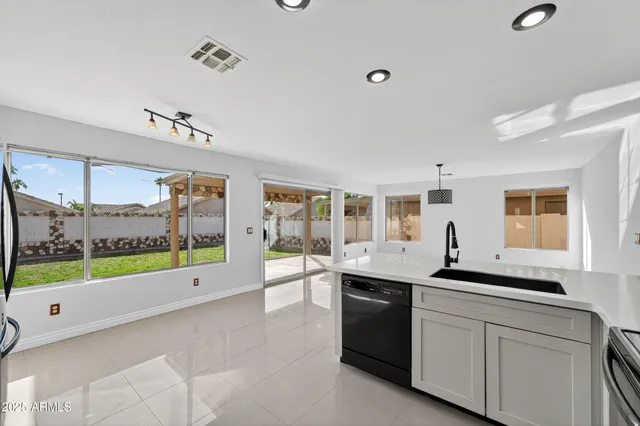 a kitchen with stainless steel appliances granite countertop a stove and a sink