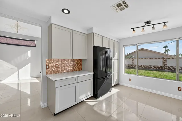 a kitchen with counter top space and windows