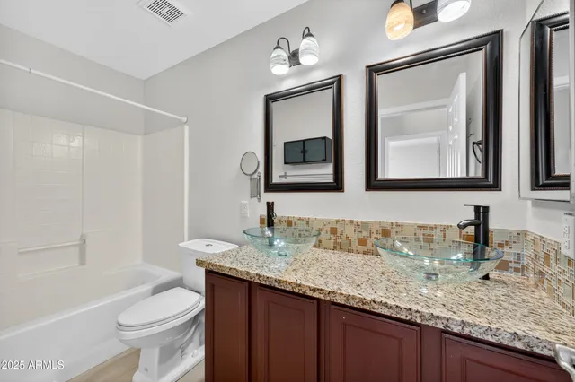 a bathroom with a double vanity sink and a mirror