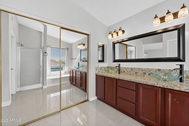 a bathroom with a granite countertop sink a toilet and a mirror
