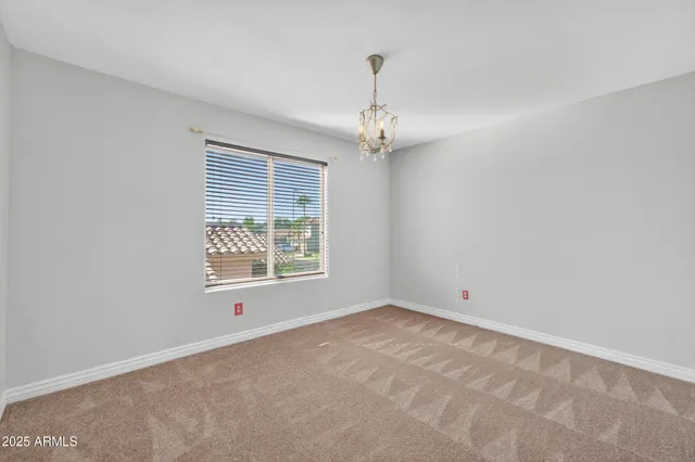 a bathroom with a granite countertop sink a toilet and a mirror