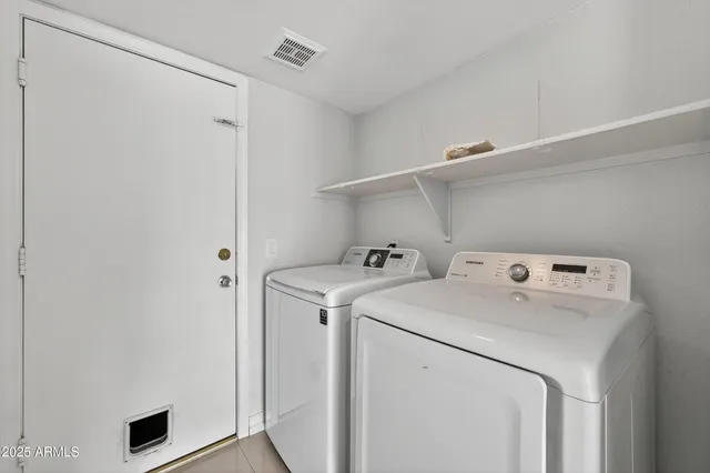 a view of empty room with wooden floor and ceiling fan
