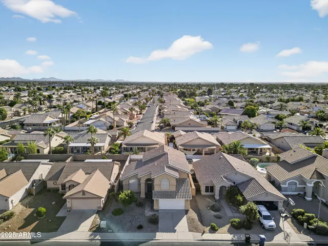 an aerial view of residential houses with outdoor space and ocean view