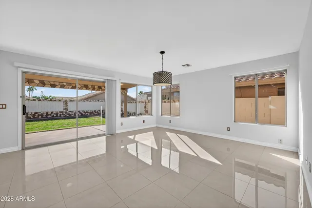 an empty room with windows and wooden floor