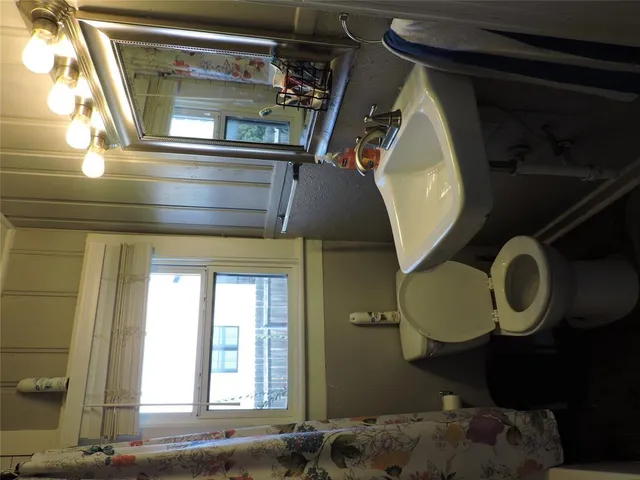 a bathroom with a mirror and a window