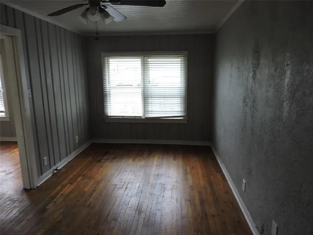a view of a room with wooden floor and windows