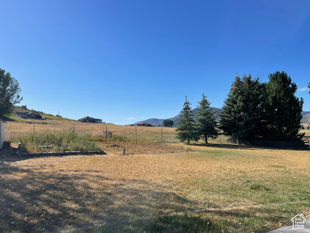 11473 South Dempsey Creek Road Lava Hot Springs, ID 83246 - Photo 41 of 47 View of grassy yard with a mountain view and a view of countryside