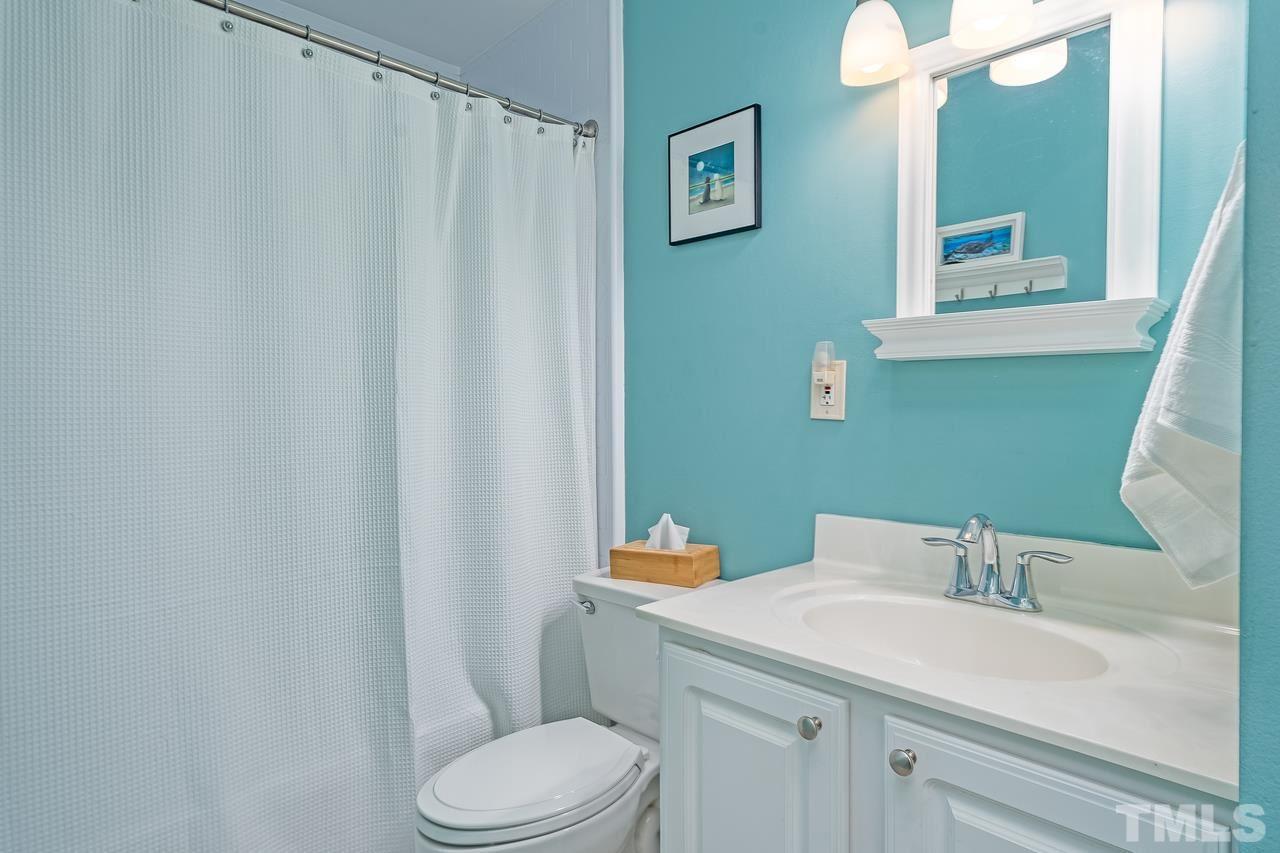505 Old Farm Road Raleigh, NC 27606 - Photo 14 of 22 a bathroom with a sink a toilet and mirror