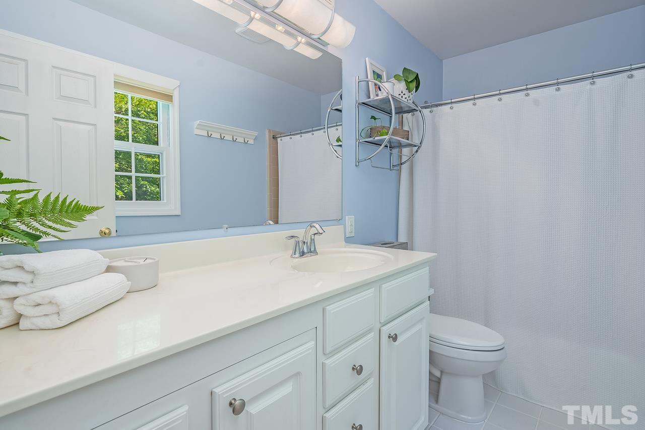 505 Old Farm Road Raleigh, NC 27606 - Photo 17 of 22 a bathroom with a sink a toilet and a mirror