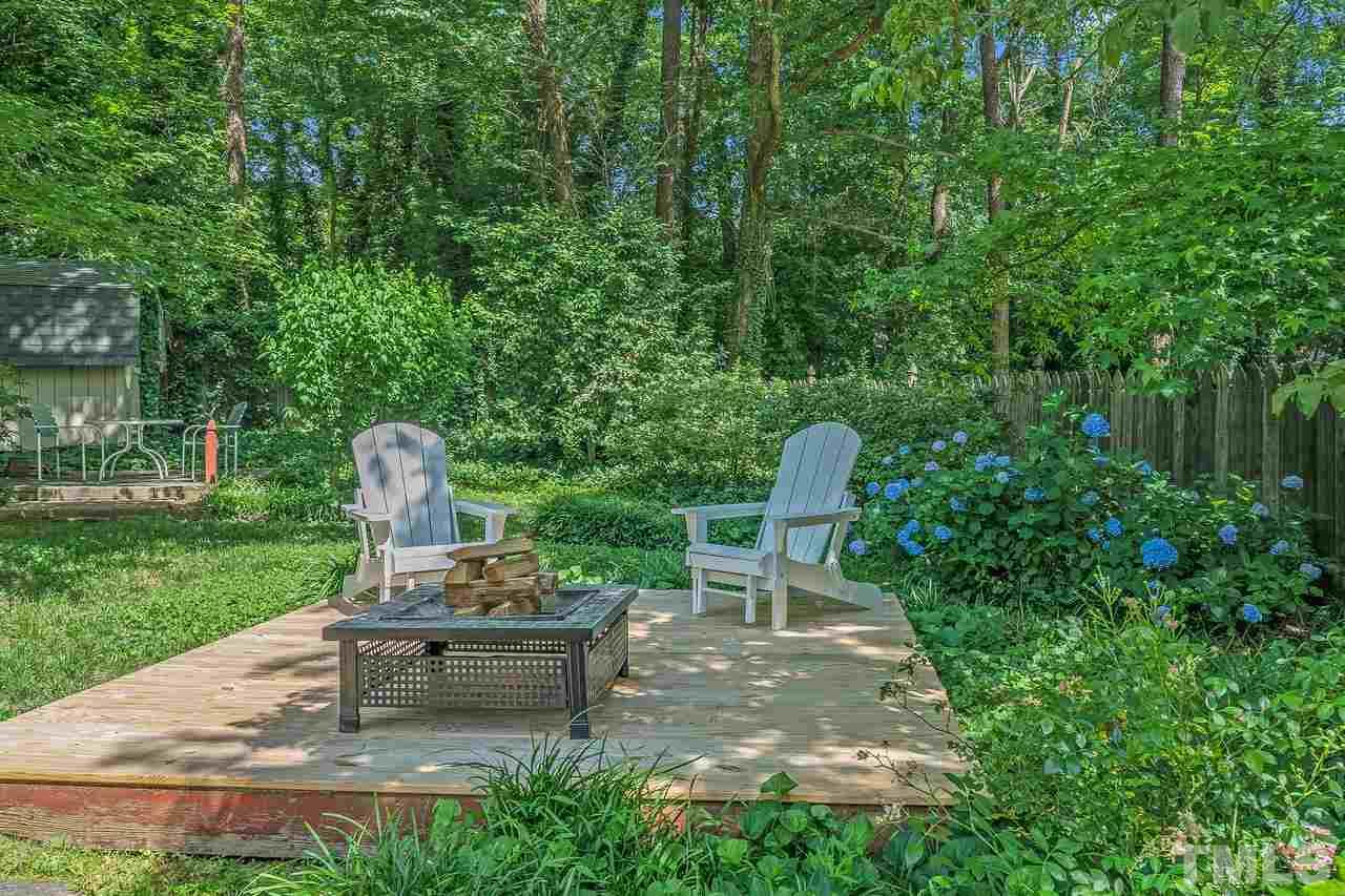 505 Old Farm Road Raleigh, NC 27606 - Photo 22 of 22 a bench sitting in the middle of a garden