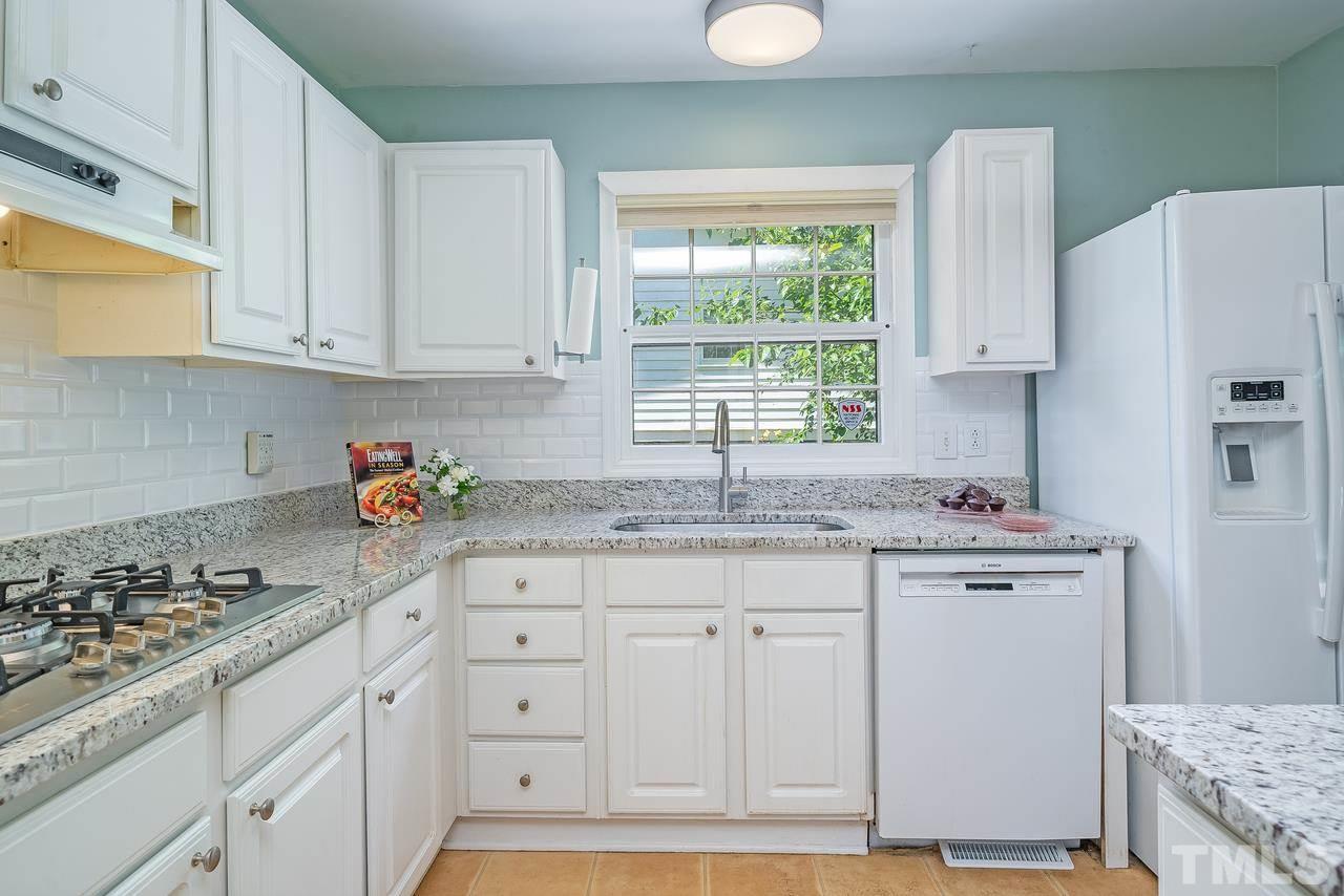 505 Old Farm Road Raleigh, NC 27606 - Photo 7 of 22 a kitchen with stainless steel appliances granite countertop a sink stove and cabinets