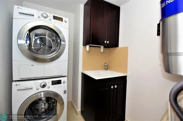 a utility room with sink dryer and washer