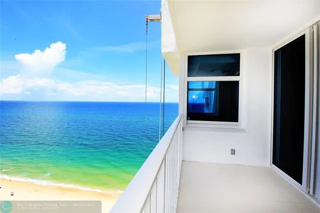 a view of hallway with a large kitchen space