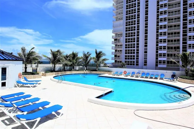 a view of swimming pool with outdoor seating