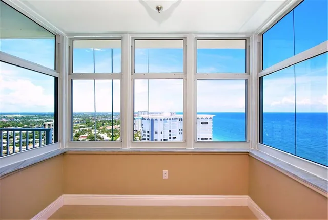 a kitchen with stainless steel appliances kitchen island granite countertop a sink refrigerator and cabinets