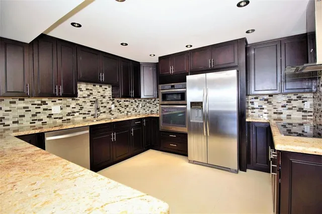 a kitchen with a refrigerator and a sink