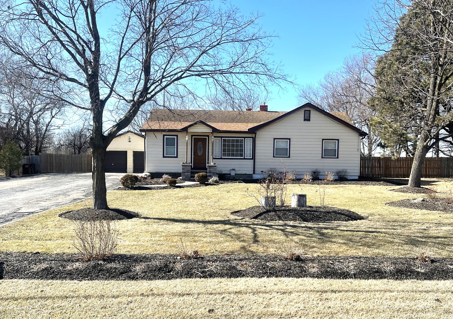 16058 South Gougar Road Homer Glen, IL 60491 - Photo 3 of 25 a view of a white house with a yard covered with snow in the background