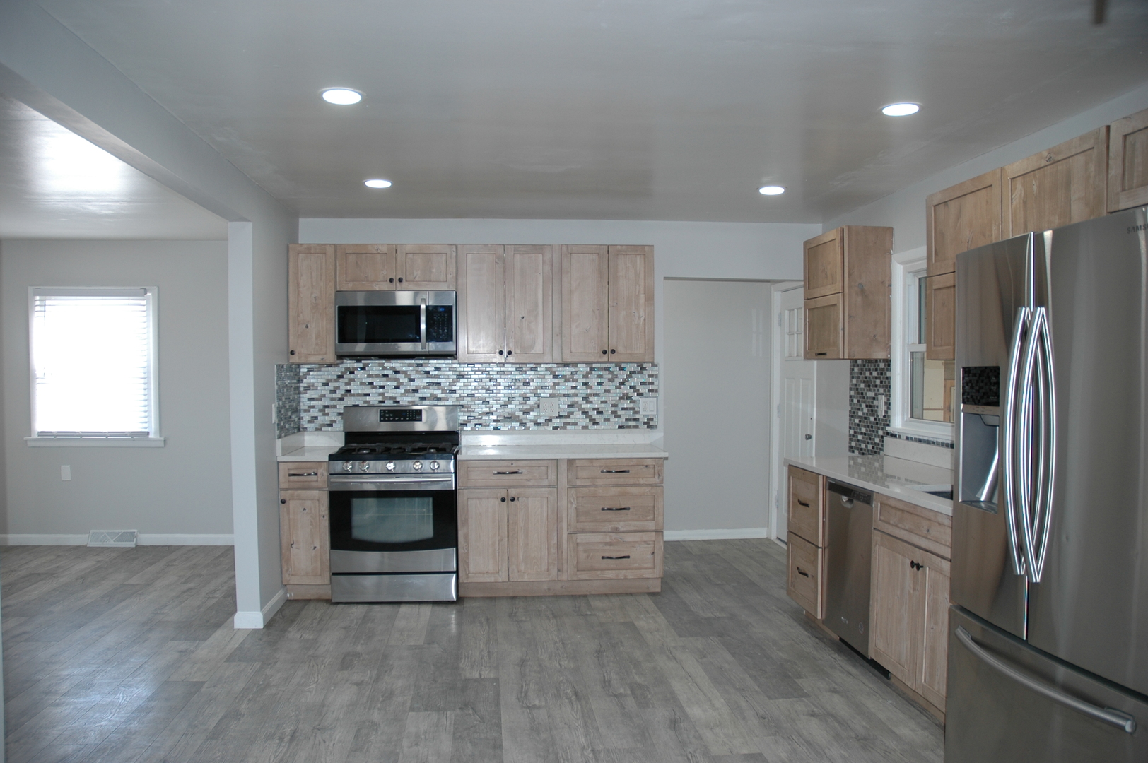 16058 South Gougar Road Homer Glen, IL 60491 - Photo 5 of 25 a kitchen with a refrigerator stove and white cabinets