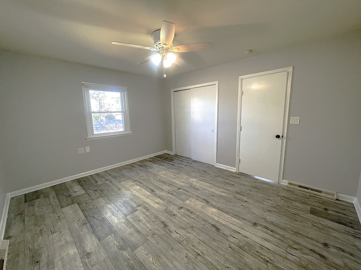 16058 South Gougar Road Homer Glen, IL 60491 - Photo 9 of 25 an empty room with wooden floor and windows