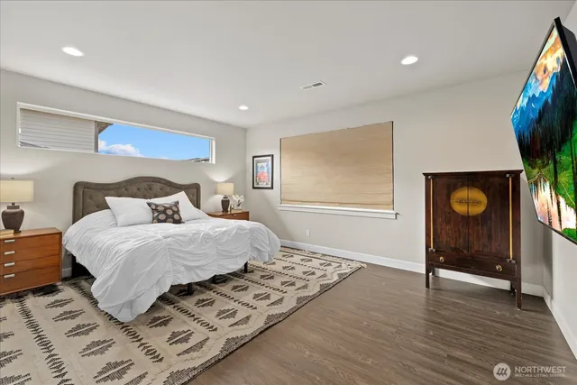 a bedroom with a bed and a flat screen tv