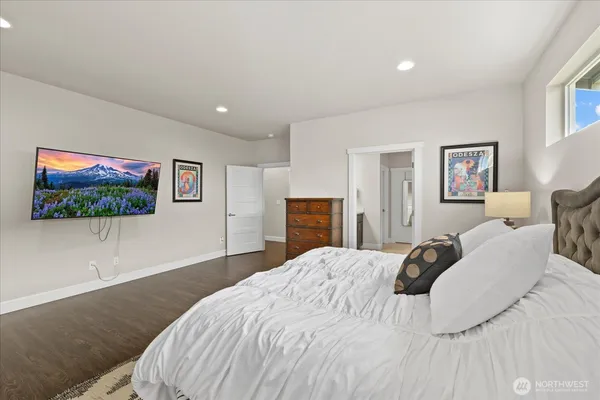 a bedroom with a bed and a flat screen tv