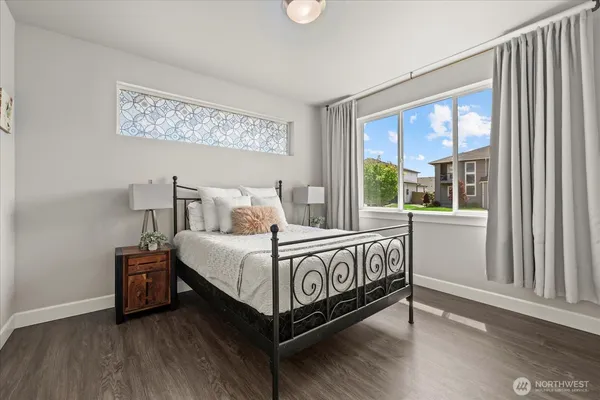 a bed sitting in a bedroom next to a window