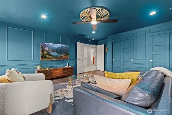 a living room with furniture and a wooden floor