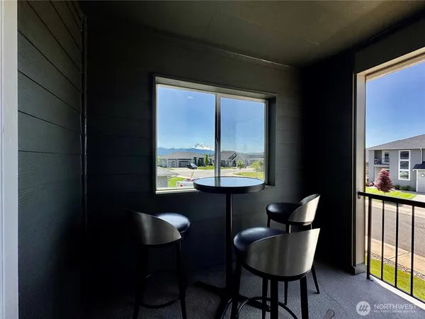 a view of a chairs and table in the balcony