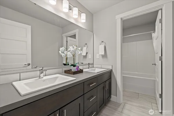 a bathroom with a sink double vanity and a mirror