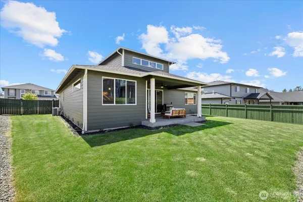 a view of a house with backyard and porch