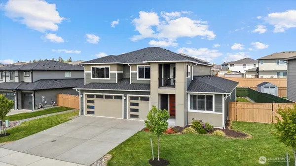 a front view of a house with a yard and garage