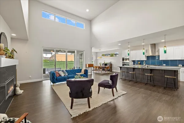 a living room with dining room and kitchen view