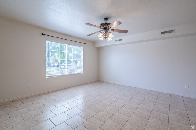 1735 West 540 North, Unit 1805 St. George, UT 84770 - Photo 13 of 64 Spacious room featuring neutral wall tones, large window with blinds, tile flooring, and a ceiling fan with integrated lighting