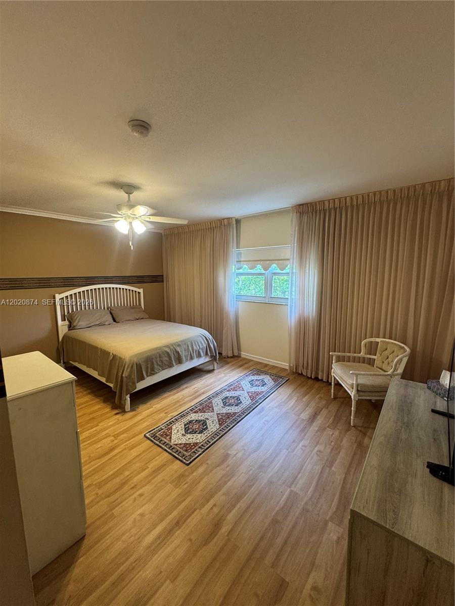 6731 Cypress Road, Unit 410 Plantation, FL 33317 - Photo 2 of 15 a bedroom with double bed and a window