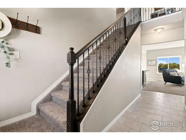 a bedroom with bed and a chandelier